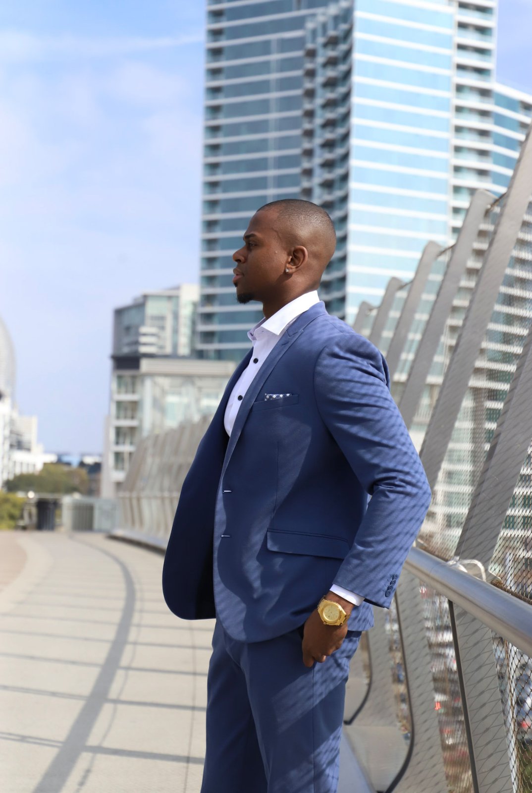 Michael K. Farley standing on a walkway in a blue suit